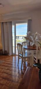 a dining room with a table and chairs with a view at Apartamento 203 Castell Sol CB in Arenal d'en Castell