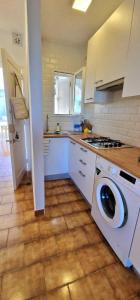 a kitchen with a washing machine in the middle at Apartamento 203 Castell Sol CB in Arenal d'en Castell