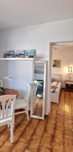 a room with a mirror and a table and a bed at Apartamento 203 Castell Sol CB in Arenal d'en Castell