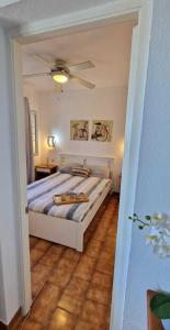 a bedroom with a bed with a ceiling fan at Apartamento 203 Castell Sol CB in Arenal d'en Castell