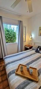 a bedroom with a bed with a tray on it at Apartamento 203 Castell Sol CB in Arenal d'en Castell