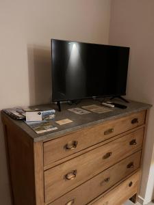 a television on top of a wooden dresser at Ca'Gialla in Bellinzona