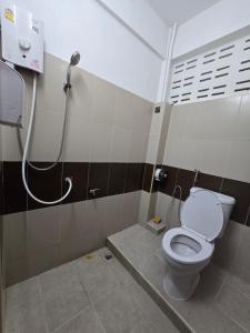 a bathroom with a toilet and a shower at Yume House in Hat Yai