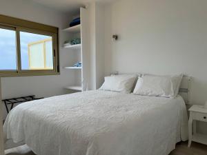 ラスパルマス・デ・グランカナリアにあるLos Gueldesの白いベッドルーム(窓付)の白いベッド1台