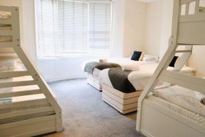 a bedroom with two bunk beds and a staircase at Modern & Glamorous Home Brighton Pier Beach SLP16 in Brighton & Hove