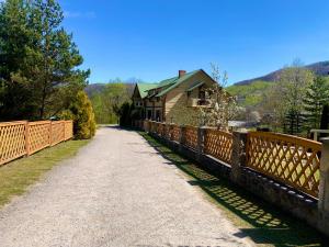 a wooden bridge with a building on the side of it at Family in Yaremche