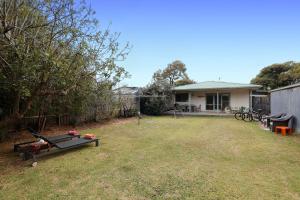 a backyard with a ping pong table in the grass at Mcrae retro beach house ! in McCrae