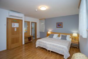 a hotel room with a bed and a door at Villa Ana Split in Split