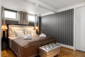 a bedroom with a bed with two towels on it at Frichs Hotel Hamar in Hamar