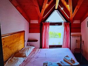 a bedroom with a bed and a large window at hotel quai in Monno