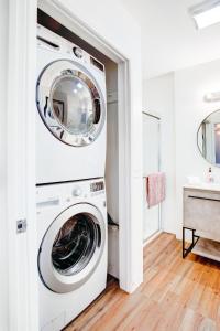 a washer and dryer in a white laundry room at Beachy Venice Bungelow off Abbot Kinney in Los Angeles