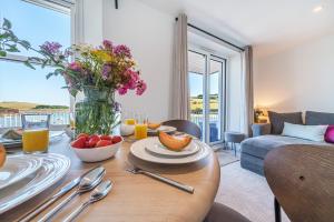 a living room with a table with a vase of flowers at N° 31 The Salcombe in Salcombe +36 photos