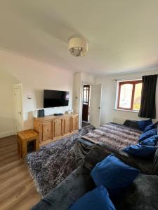 a living room with a bed and a flat screen tv at Cosy Home In The Heart Of Sussex in Burgess Hill