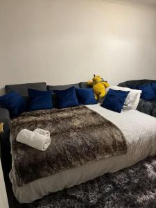 a bed with a stuffed animal sitting on top of it at Cosy Home In The Heart Of Sussex in Burgess Hill