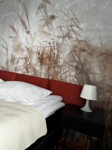 a bedroom with a bed and a painting on the wall at Delta Apart-House in Wrocław