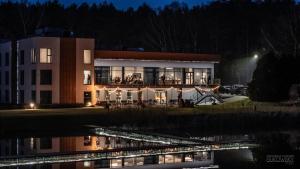 a building with lights in front of it at night at Hotel Odpocznia Resort i Las in Jaracz