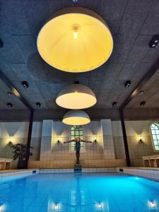 a person is standing in front of a swimming pool at Hotel 1622 - Adults only in Helsingborg