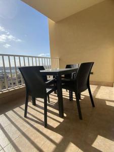 a table and chairs on a balcony with a view at Central Sliema 3bdr. Apartment in Sliema