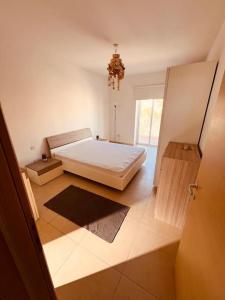 a bedroom with a white bed and a window at Central Sliema 3bdr. Apartment in Sliema