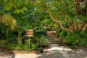 a set of stairs in a park with a sign at Zuri Zanzibar in Kendwa