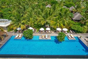 an aerial view of a resort pool with chairs and umbrellas at Zuri Zanzibar in Kendwa