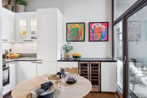 a kitchen with a wooden table with glasses on it at Bryggeleilighet med balkong i Trondheim Sentrum in Trondheim