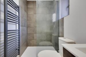 a bathroom with a shower and a toilet and a sink at Ashley Road Apartments in Poole