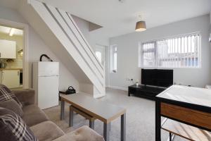 a living room with a couch and a table at Ashley Road Apartments in Poole