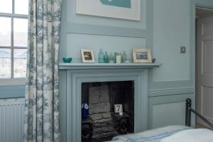 a fireplace in a room with a window at ※ Beautiful Georgian Apartment - Central Bath ※ in Bath