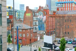 a building with a large mural on the side of it at Pass the Keys City Center Ancoats Northern Quarter 1 Min Walk in Manchester