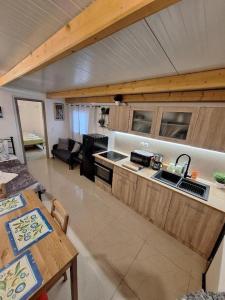 a kitchen and living room with a table and a couch at Johnson House in Rafina
