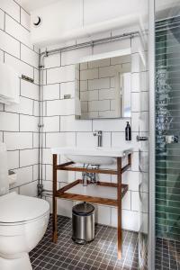 a bathroom with a sink and a toilet at xhotel in Ludvika