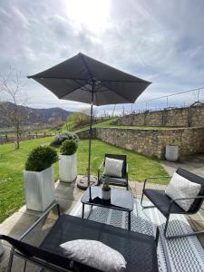 a patio with a table and an umbrella at Wachaulodge in Weissenkirchen in der Wachau