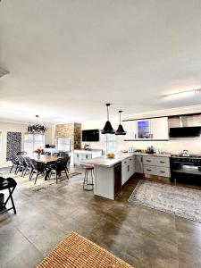 a kitchen and dining room with a table and chairs at 4 Bedroom Home, St Francis Links Golf Estate in St Francis Bay