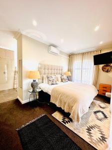 a bedroom with a large bed and a window at 4 Bedroom Home, St Francis Links Golf Estate in St Francis Bay