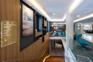 a lobby with a long table and chairs at Nemea Appart Hotel Cannes Palais in Cannes