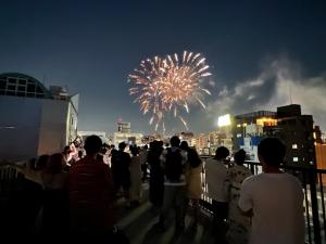 a crowd of people watching a fireworks show at Ano Hotel Asakusa in Tokyo