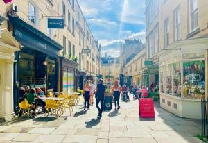 a group of people walking down a city street at Spacious City Centre Apartment Bath in Bath