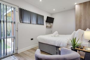 a bedroom with a bed and a tv in it at Little Paddock in Ringwood