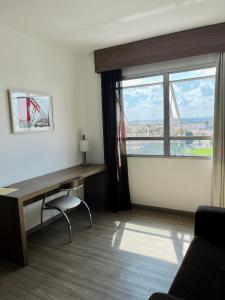 貝洛奧里藏特的住宿－LK Barro Preto 9，客房设有书桌和大窗户。