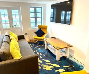 a living room with a couch and a coffee table at Harbour Lights Apartment New Quay in New Quay