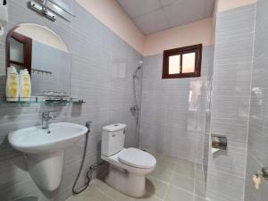 a bathroom with a toilet and a sink and a shower at Con Dao Tan Son Nhat Hotel in Con Dao