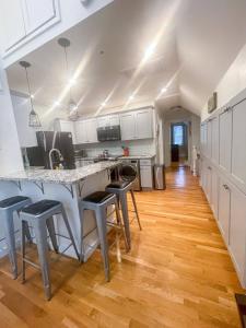 a kitchen with a table and some chairs in it at Modern, Newly Renovated 3bed, 2bath, Steps To Mbta in Boston