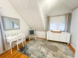 a bedroom with a desk and a dresser and a window at Modern, Newly Renovated 3bed, 2bath, Steps To Mbta in Boston