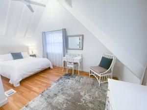 a bedroom with a bed and a table and chairs at Modern, Newly Renovated 3bed, 2bath, Steps To Mbta in Boston