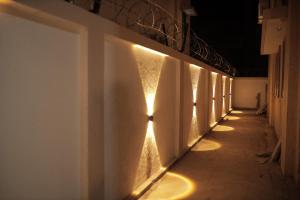 a hallway with lights on the side of a building at Kookee Villa in Hātgarh