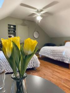 een vaas met gele bloemen op een tafel in een kamer bij Quay Lane Studio Apartment in Ballina