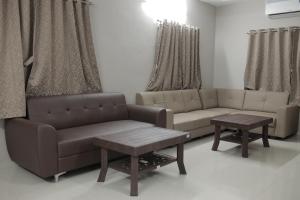 a living room with two couches and a table at Kookee Villa in Hātgarh