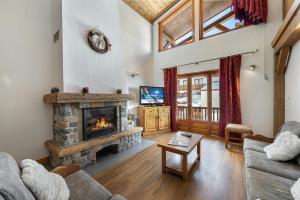 a living room with a fireplace and a couch at Les Suites du Val Claret in Tignes