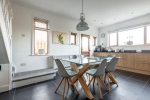 a kitchen with a dining room table and chairs at Livingstone Lodge in St. Andrews